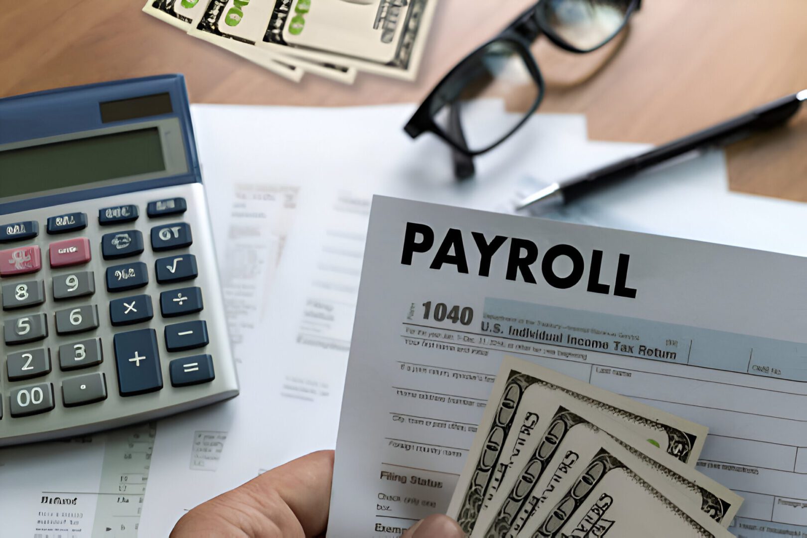 Payroll document with money and calculator.